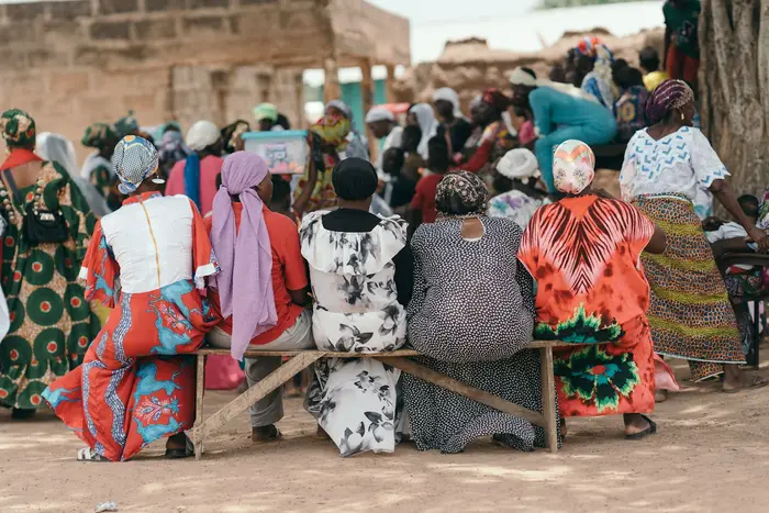 Community members seated together at an outdoor gathering